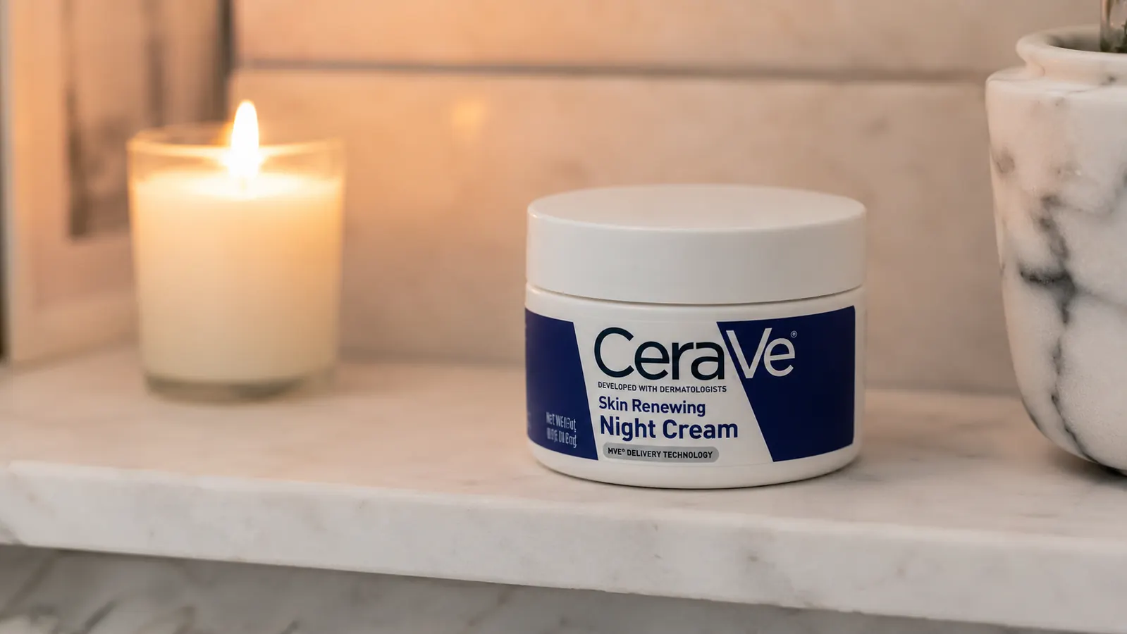 CeraVe Skin Renewing Night Cream jar on a marble bathroom counter with soft warm lighting